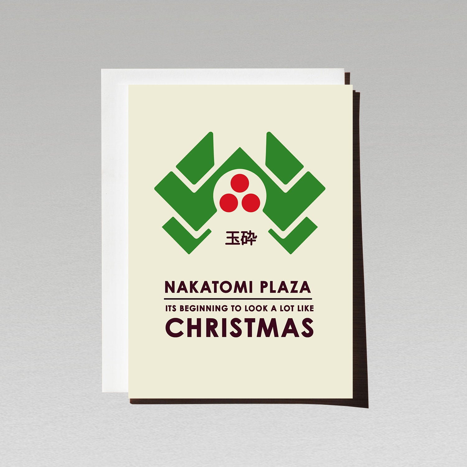 die hard christmas card with green nakatomi plaza with three red dots with text its beginning to look a lot like christmas